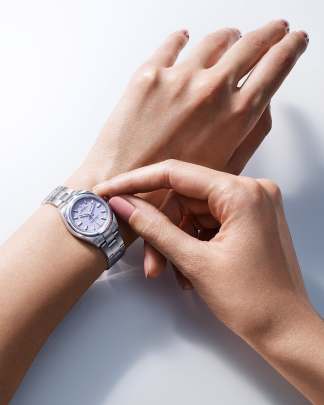 Rolex Oyster Perpetual watch featuring a pink dial and an Oyster bracelet.  Rolex